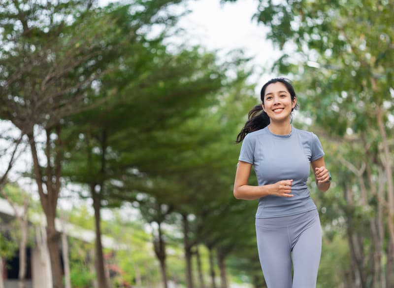 A woman jogging through a park
