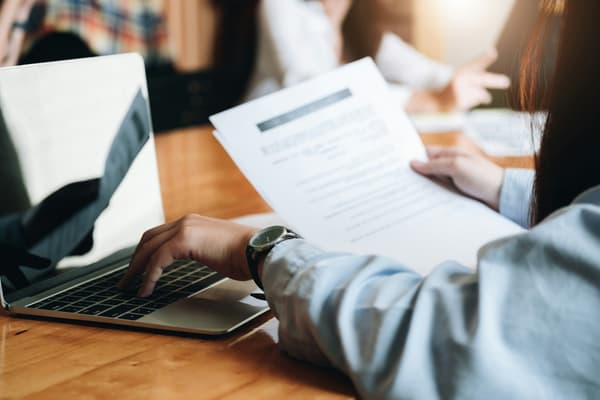 Hands reviewing printed documents