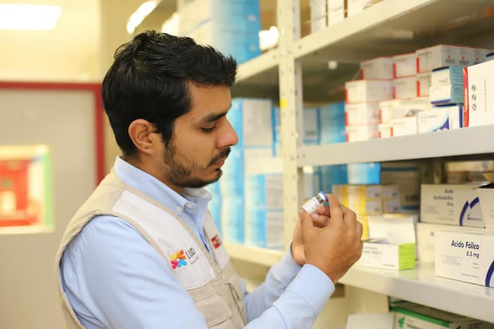 A pharmacist examining a product